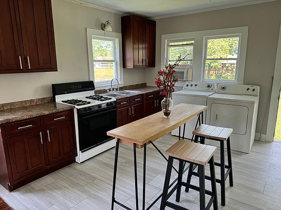 Beautiful tall cabinets, light colors, new appliances to follow, washer and dryer to use while they work. Opens up to backyard with pecan and fig trees.