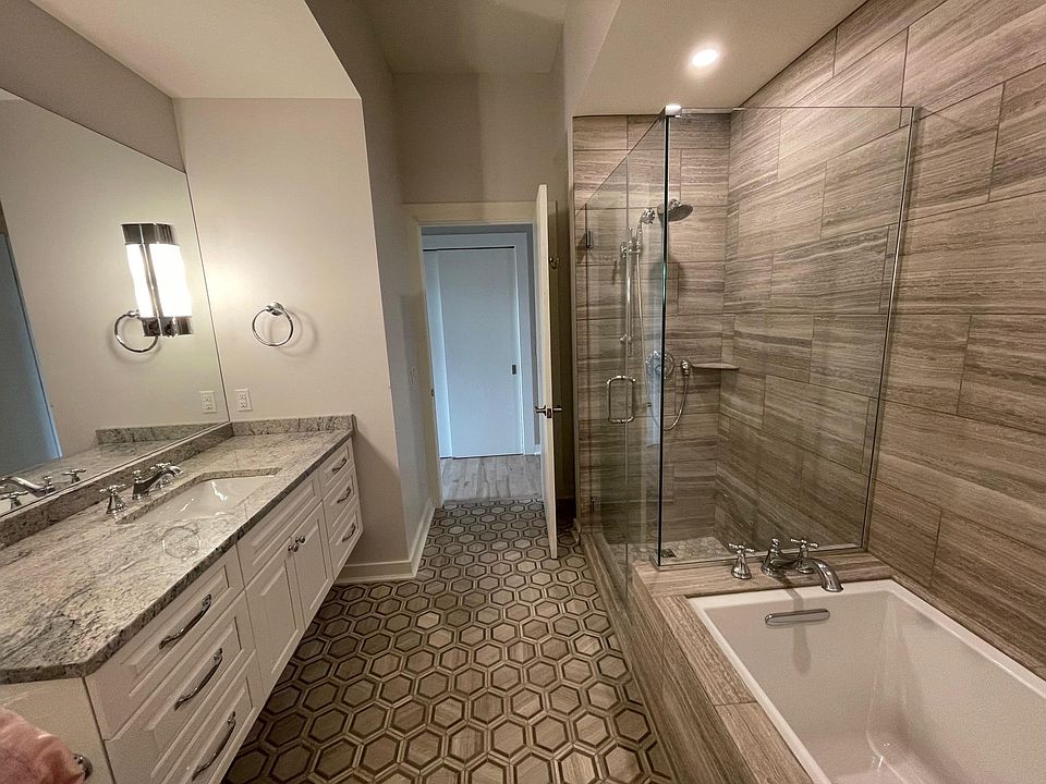 Spacious, tiled primary bathroom,