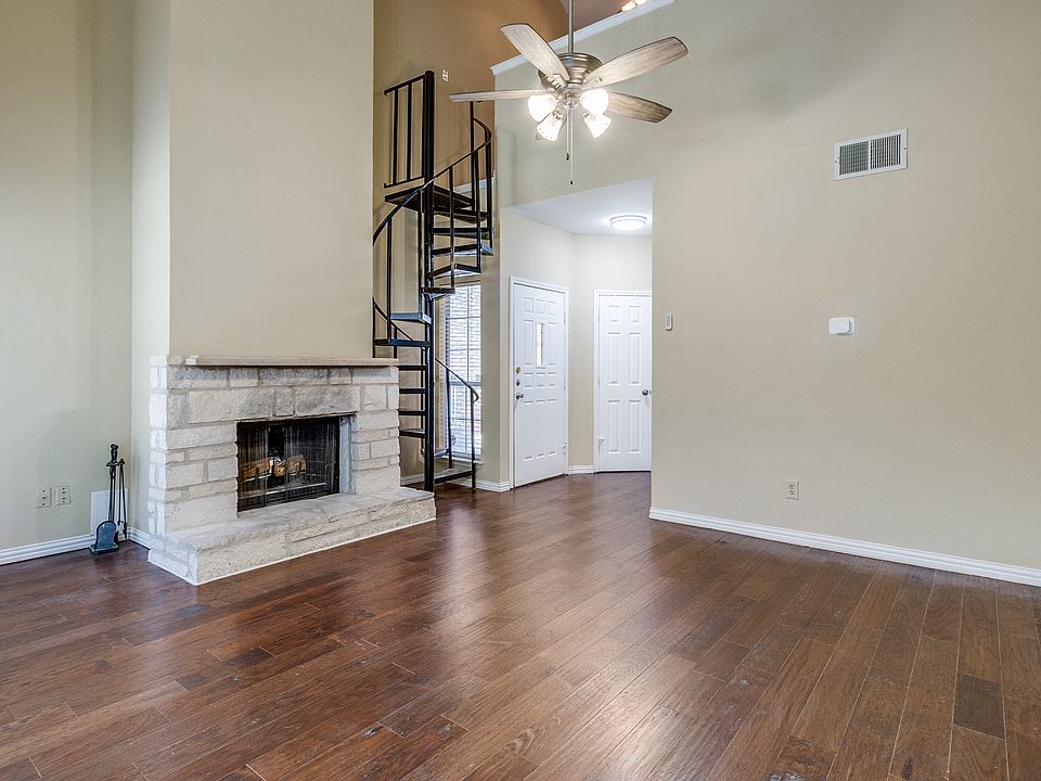 Living Room - view of wood-burning fireplace and spiral staircase to the loft area.