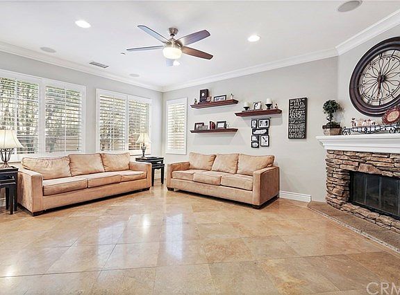 Kitchen opens to Family Room, complete with stone stacked fireplace and ceiling fan.