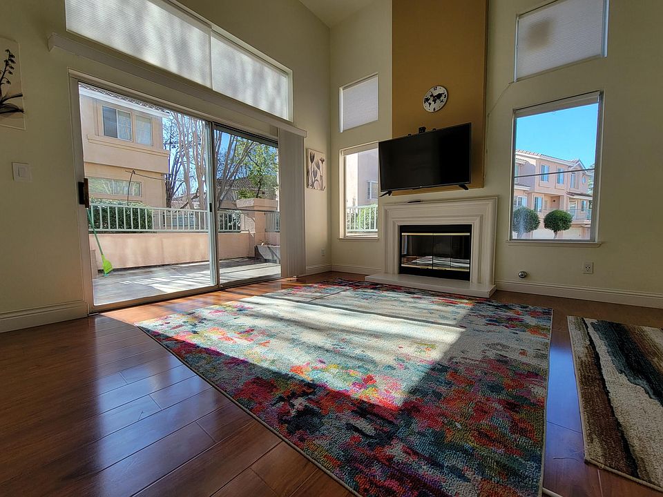 Ground level high ceiling sun room with access to patio.