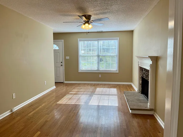 Living room with fireplace. This will have new floors, walls and the ceilings will be smooth. No more popcorn ceiling on lower level.