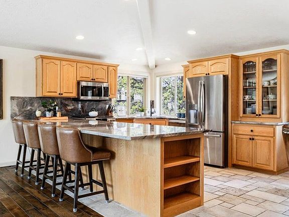 Kitchen with quartzite countertops, stainless appliances and breakfast bar