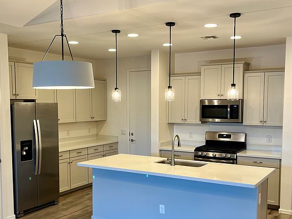 Upgraded kitchen with modern amenities. Spacious layout for entertaining. Space accompanies both seating at island and separate dining table.