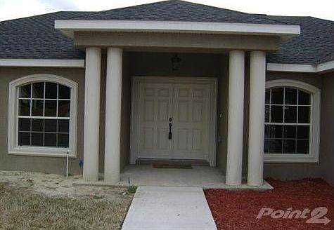 DOUBLE COLUMNS ADORN THE FRONT ENTRYWAY