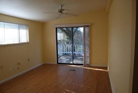 Bedroom, with sliding door to the deck that wraps around to the front of the cottage.