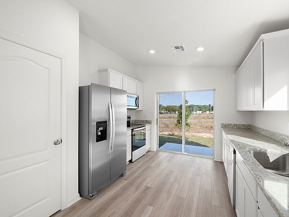 The kitchen flows seamlessly into the back yard