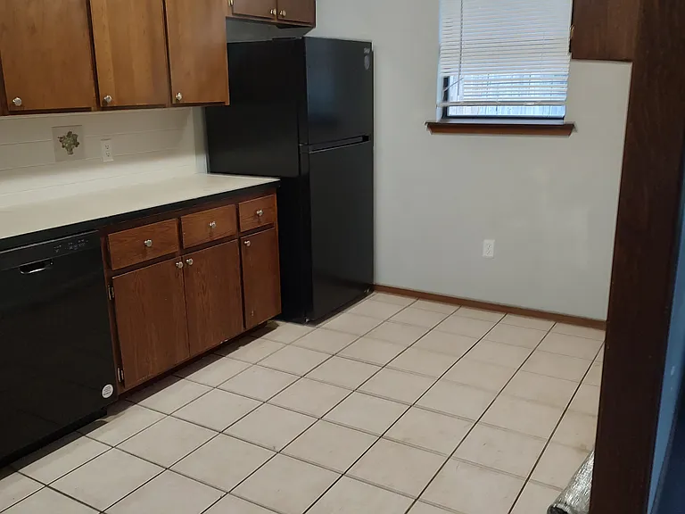 Other half of kitchen with brand new refridgerator.