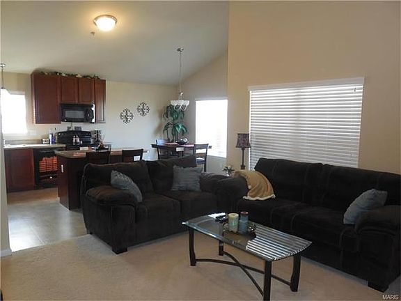 Open floor plan with kitchen open to vaulted great room.