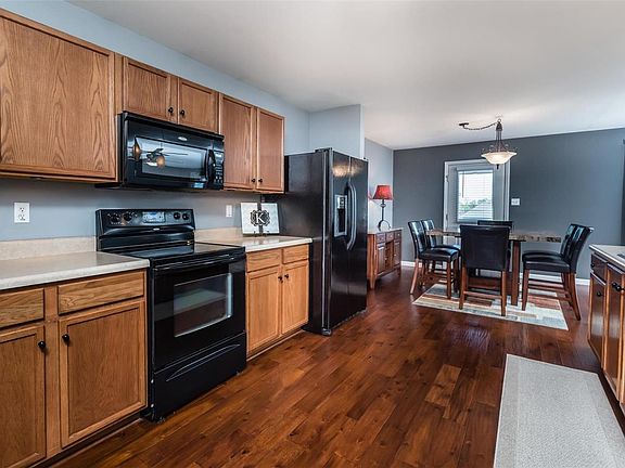Spacious kitchen w loads of cabinets and sleek appliances.