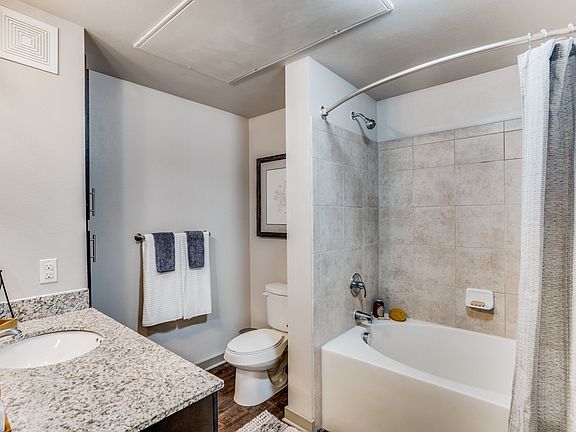 large bathroom with garden tub and granite countertops