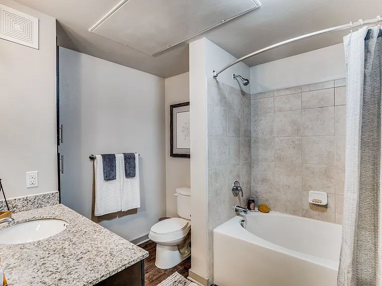 large bathroom with garden tub and granite countertops