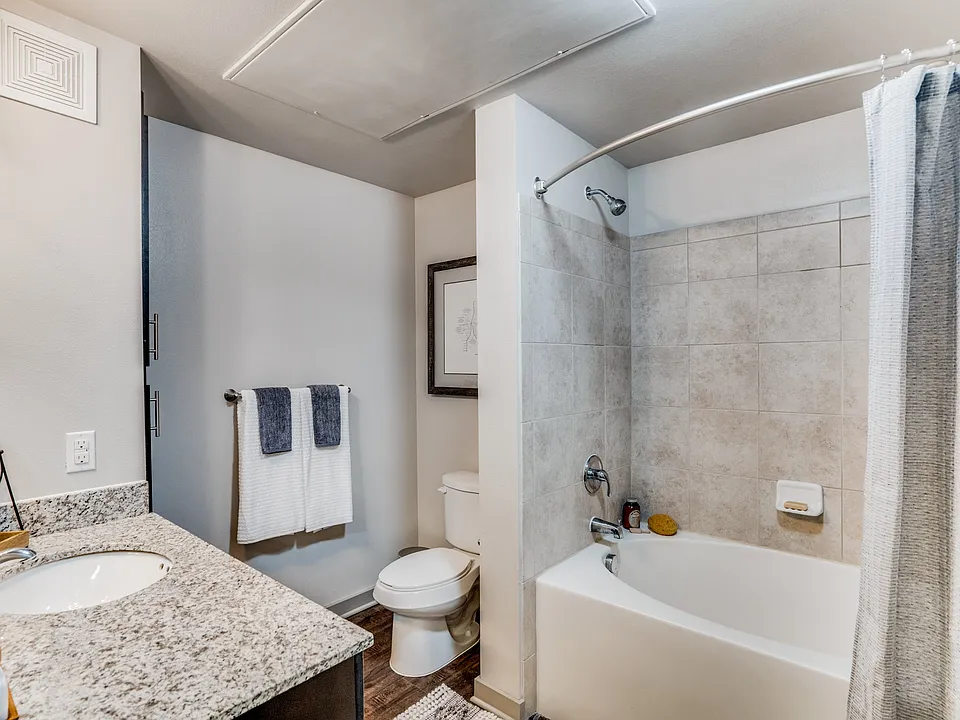 large bathroom with garden tub and granite countertops