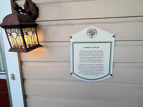 Plaque on the house that is showing its historic value.