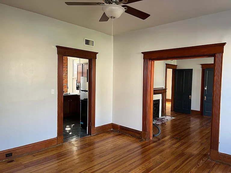 View of the entry to the kitchen on the left, and the front Living Room to the right.