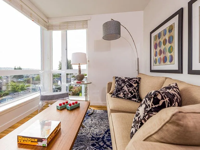 A well-furnished living room in Lillehammer Apartments with a scenic view.