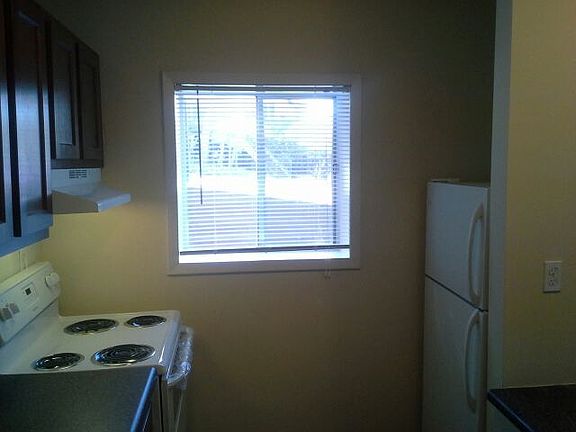 Natural light warms the kitchen and dining area across the o
