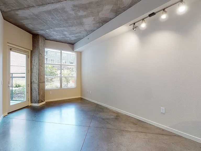 Apartment living room with polished concrete flooring.