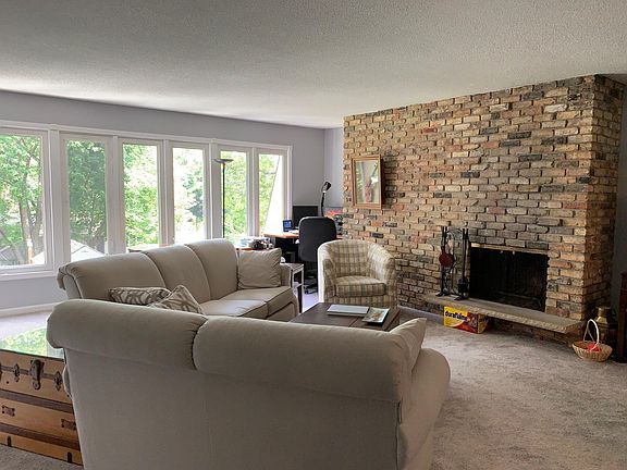Upstairs large living room with wood burning fireplace and lots of windows.