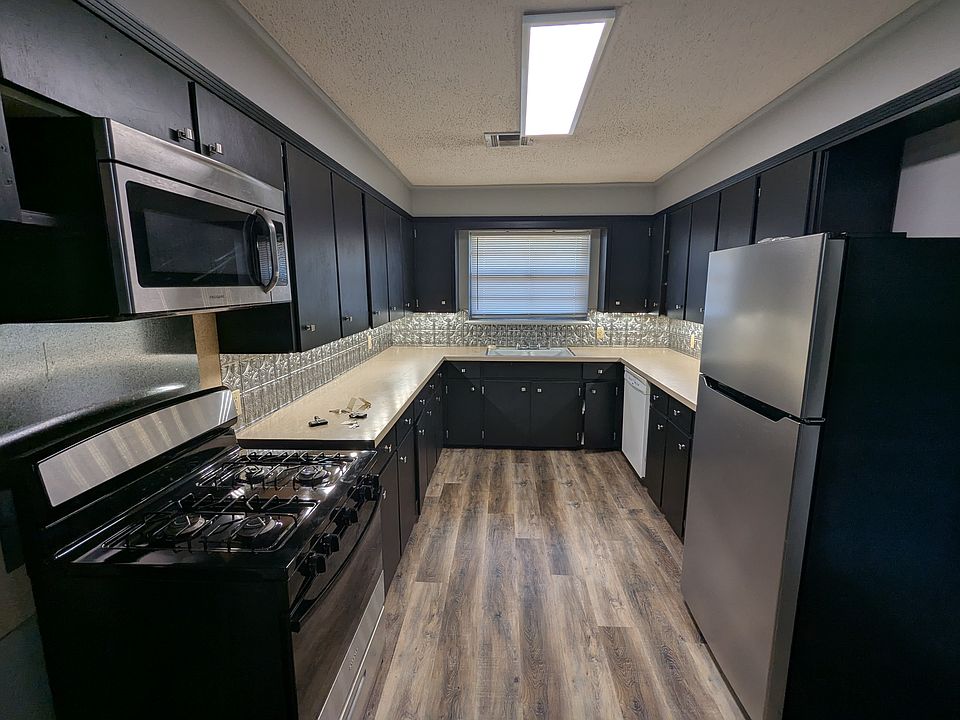 Kitchen with new appliances and under-cabinet lighting.