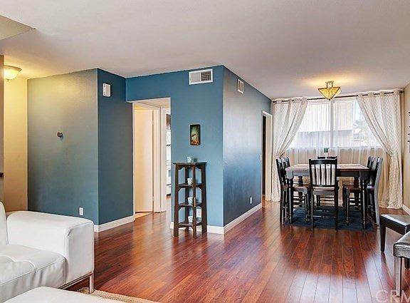 This is the view from the living area, looking towards the kitchen and dining area. There is a half bath for your guests in the corridor there too!