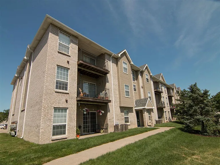 Exterior of building with lots of green space.