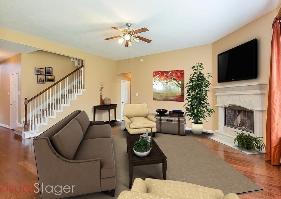 Great family room with wood floors and cozy fireplace.  Open to kitchen.