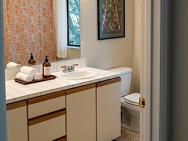 Guest bathroom with 2 sinks, full bath and shower.