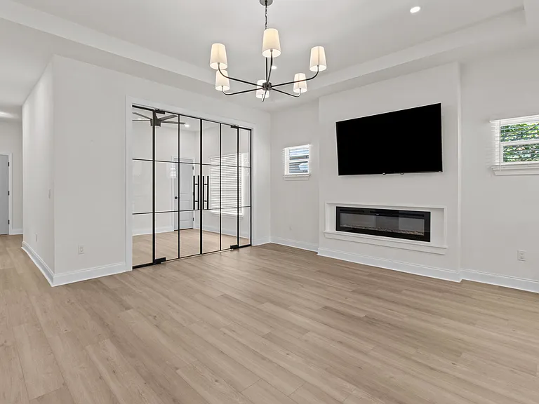 Living room, TV, gas fireplace, glass entry to bedroom 4/office