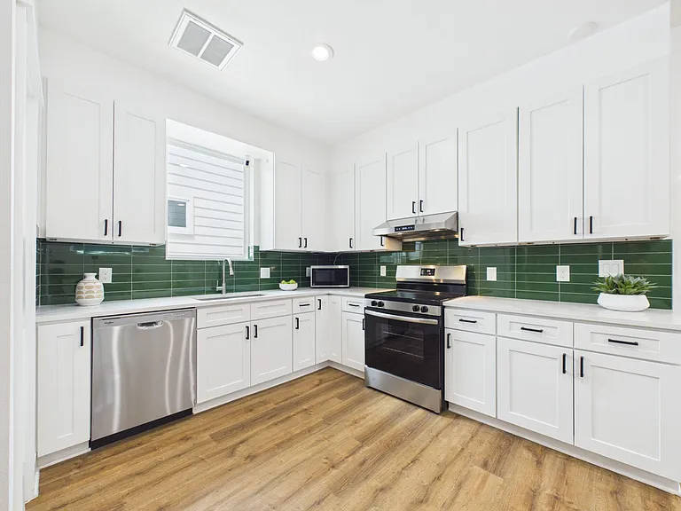 U-shaped kitchen with ample cabinetry, generous counters, and stainless steel appliances for easy everyday cooking.