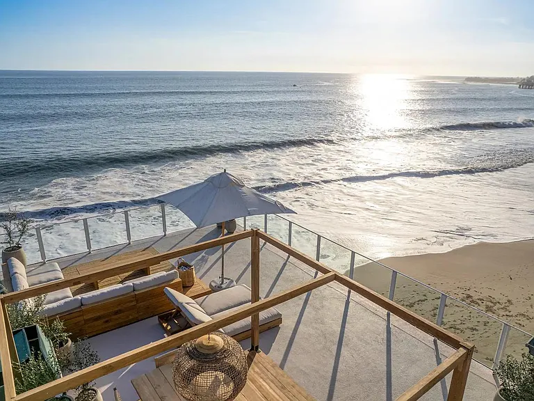 Savor private moments on the deck, a tranquil space with direct beach access just steps away.