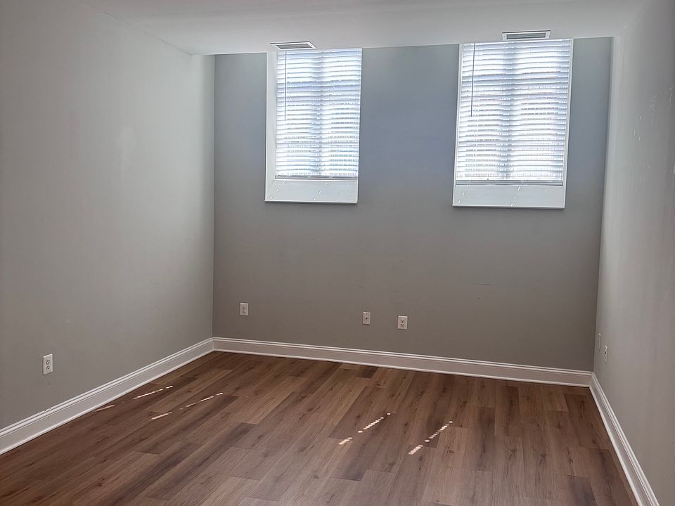Living room with no furniture. Vinyl wood flooring