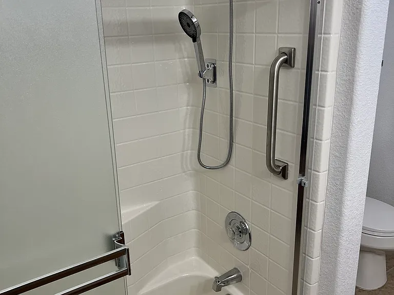 Master bath sunken tub with new shower set.