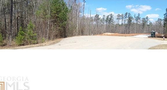 Lot is wooded on left in picture