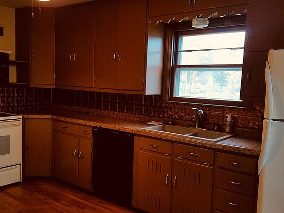 Kitchen includes a large pantry closet, dishwasher, refrigerator, microwave and oven.