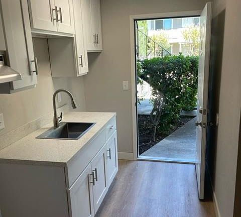 Entry and kitchen without appliances installed.