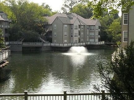 Tranquil complex surrounded by trees with a lovely pond.