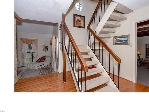 Open stairs in the foyer also has an operational octagon window.