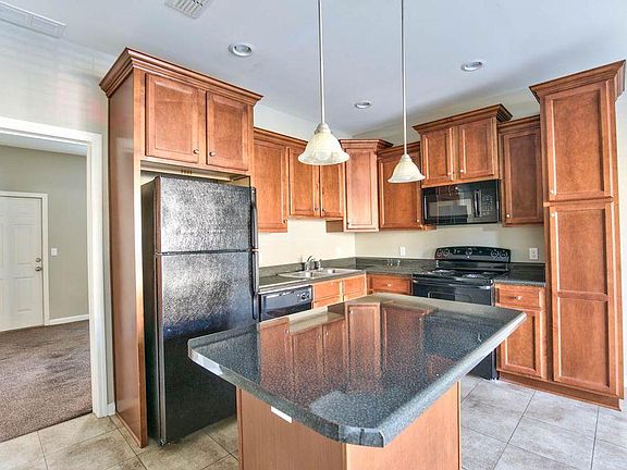 Open Kitchen features center island, refrigerator, stove, mi