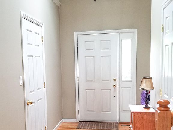 Hardwood floor entry with vaulted ceilings.