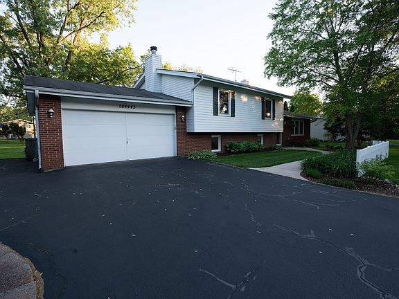 Extra wide driveway with 3rd car pad.