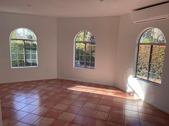 Large bright windows look out to the private yard