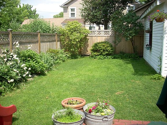 Fully fenced-in backyard with brick patio