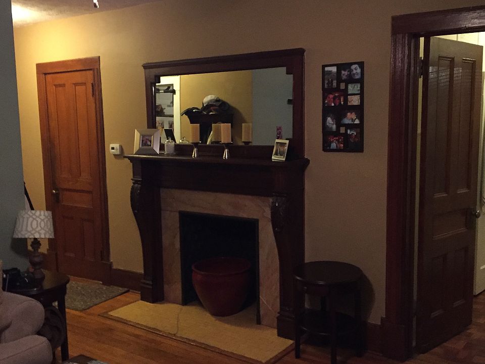 Living room with antique wooden and marble fireplace