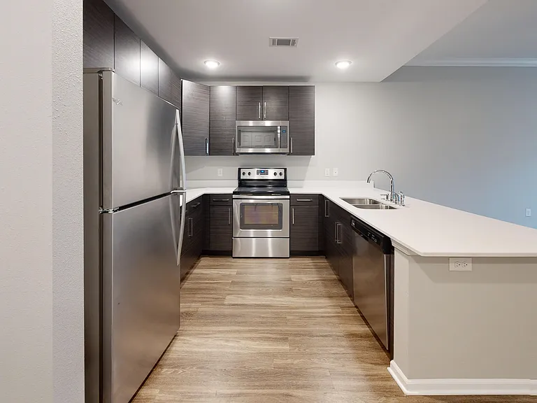 The Buckeye's kitchen features quartz counters and stainless steel appliances, including a dishwasher and microwave. The Buckeye's kitchen features quartz counters and stainless steel appliances, including a dishwasher and microwave.