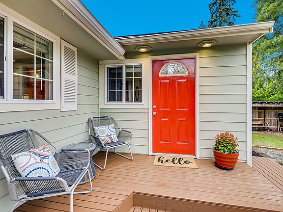 Cheery front door and deck, perfect for sitting.