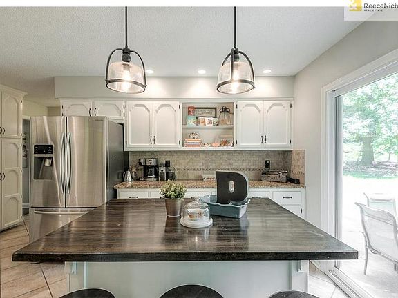 Completely updated kitchen with tons of space for entertaining and creating meals. Lovely pendant lighting and new doors lead out to your huge backyard.