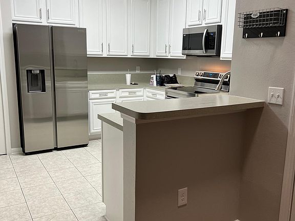 Updated Kitchen with Freshly Painted Cabinets, Brand New Appliance Package, New Disposal and lighting
