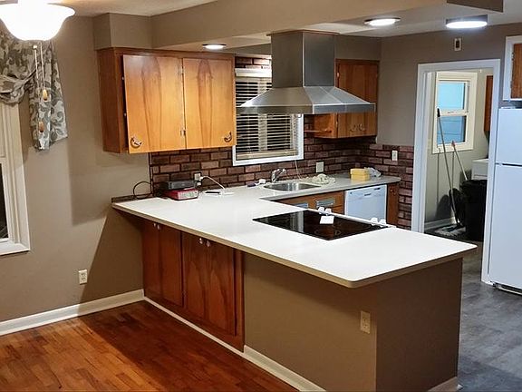 Dining area and open kitchen, glass top electric range.