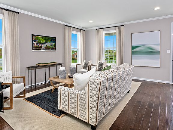Living room with LVP floors and multiple windows in a DRB Homes Oakton Plan at the WestRidge at West